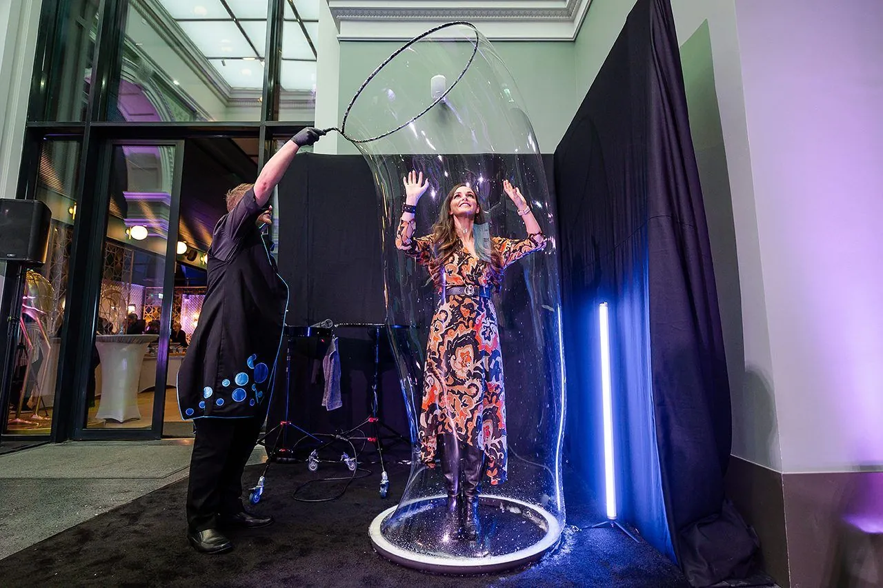 Finale: a guest smiling from inside a bubble