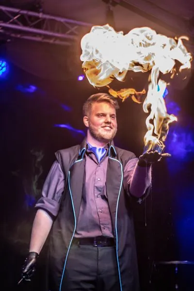 Flames rising above his hand