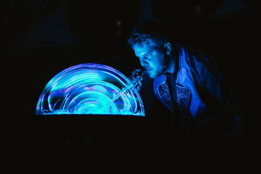 Blowing a bubble dome in blue light
